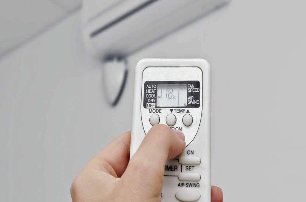  A person is holding a remote control and pointing it at an air conditioner, with the query 'Remote AC LG di HP tidak berfungsi' meaning 'LG AC remote on cellphone not working'.